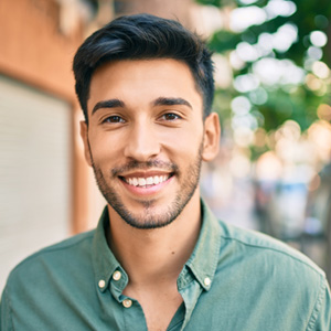 Man in green shirt smiling