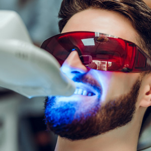 Man with protective glasses receiving teeth whitening