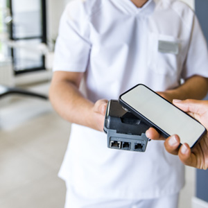 POV of patient using cell phone to pay for care