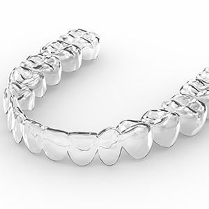 Clear aligners on a white surface demonstrating its transparency