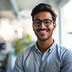 Man with glasses smiling in office