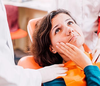 Woman with a toothache at the dentist