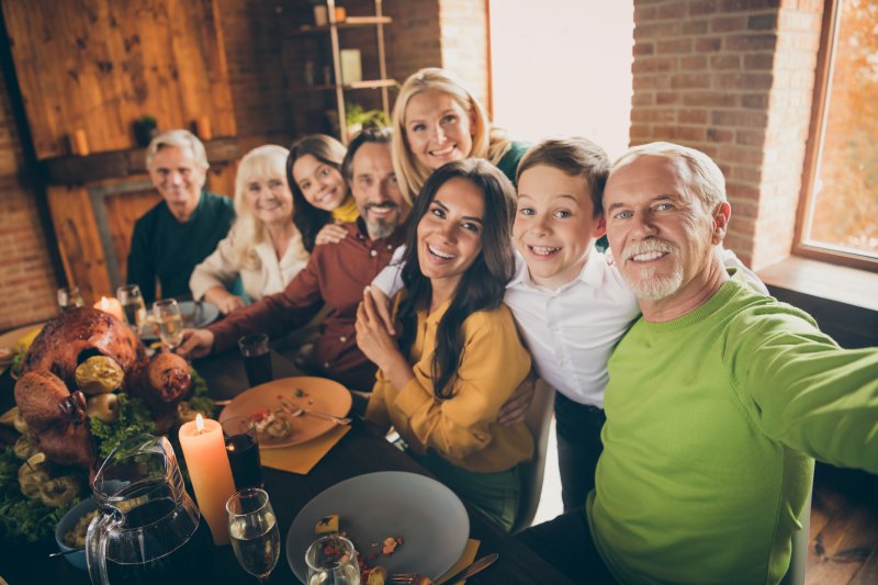 family smiling at Thanksgiving 