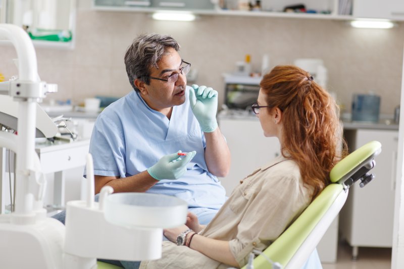 Patient talking to dentist about dental implants